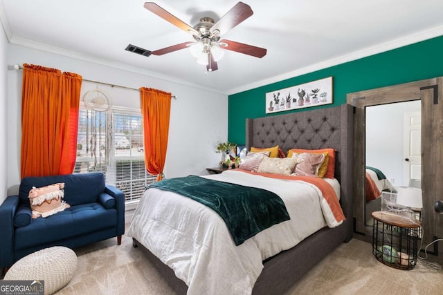 bedroom with crown molding, ceiling fan, and carpet flooring