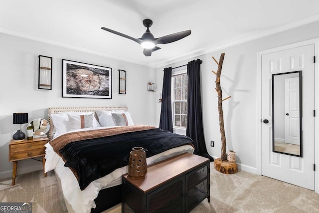 carpeted bedroom with ceiling fan and ornamental molding