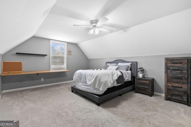 bedroom featuring vaulted ceiling, light colored carpet, and ceiling fan