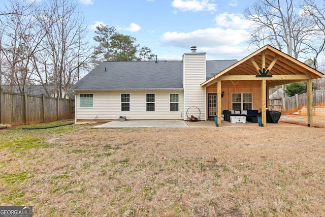 rear view of property with a yard, a patio, and ceiling fan