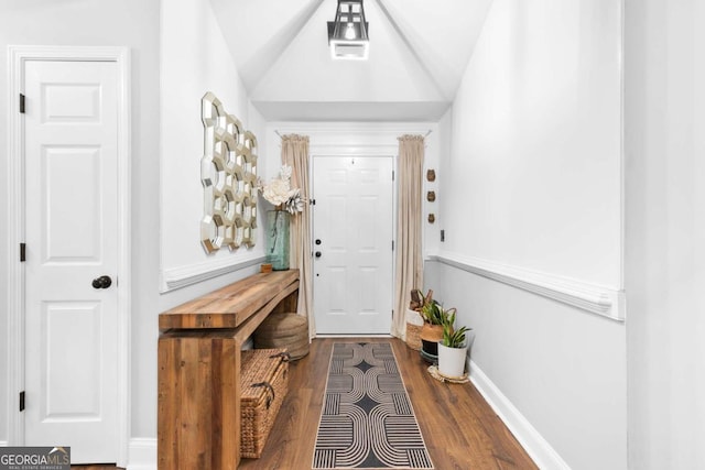 interior space featuring wood-type flooring and vaulted ceiling