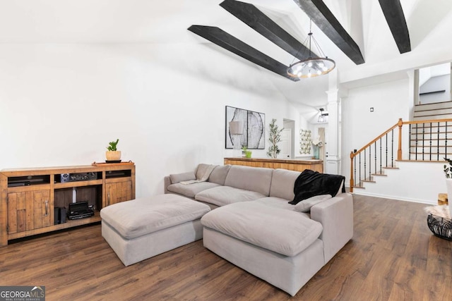 living room featuring dark wood-type flooring, ornate columns, and vaulted ceiling with beams