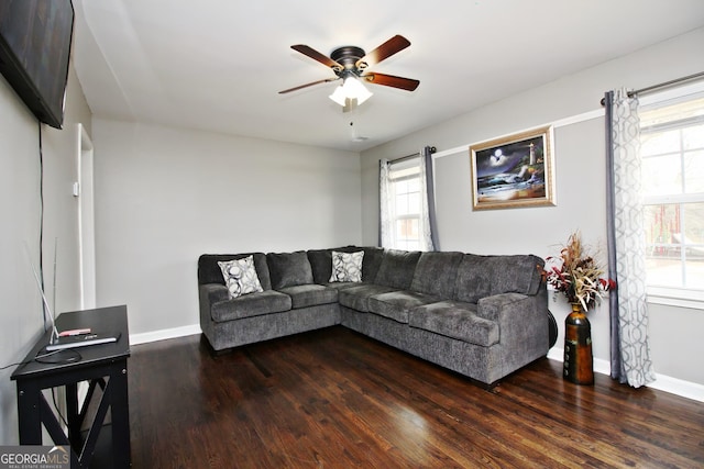 living room with ceiling fan and dark hardwood / wood-style floors