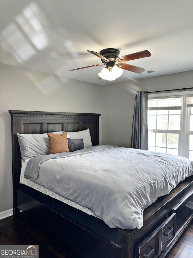 bedroom featuring dark hardwood / wood-style flooring and ceiling fan