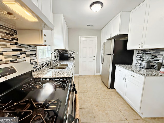 kitchen with appliances with stainless steel finishes, sink, exhaust hood, and white cabinets