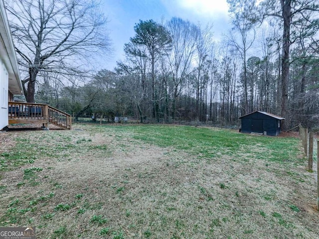 view of yard with a wooden deck and an outbuilding