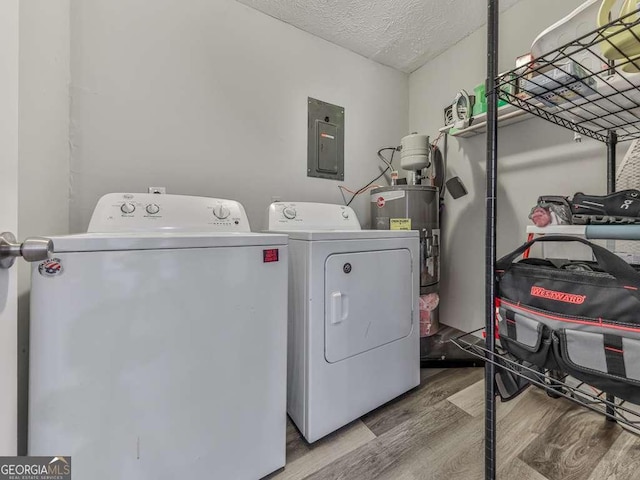 525 Henson Cir, Carrollton, GA 30117 - laundry room with electric panel, separate washer and dryer, wood finished floors, water heater, and a textured ceiling