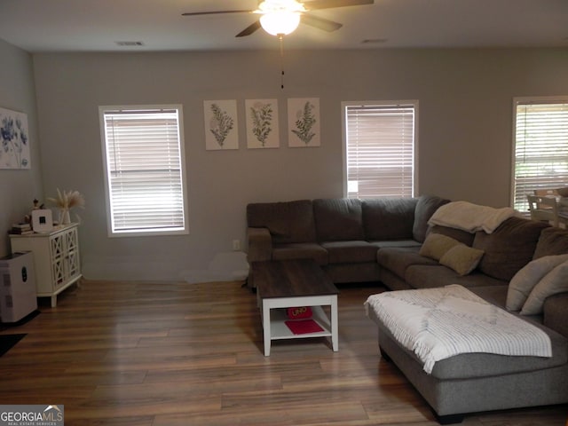 living room with dark hardwood / wood-style floors and ceiling fan
