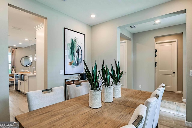 dining space featuring sink and light hardwood / wood-style flooring