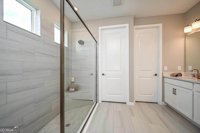 bathroom featuring vanity and an enclosed shower