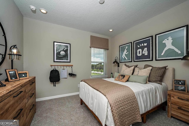 carpeted bedroom featuring a textured ceiling