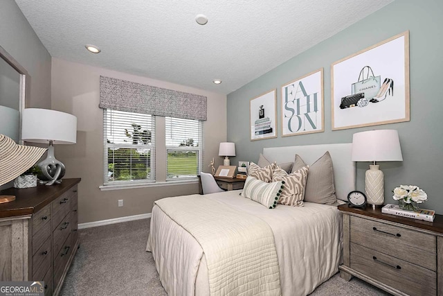 carpeted bedroom featuring a textured ceiling