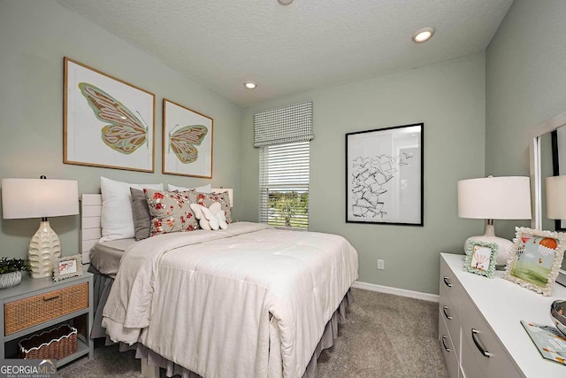 carpeted bedroom featuring a textured ceiling