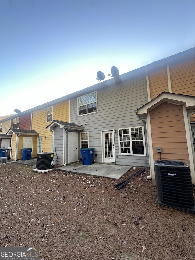 back of property featuring central AC and a patio