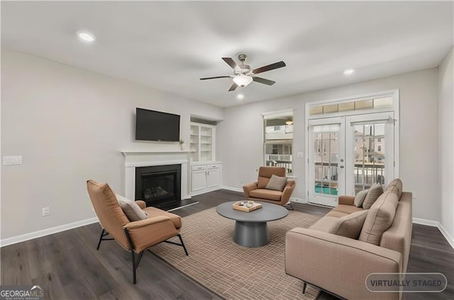 living room with dark hardwood / wood-style floors, ceiling fan, and french doors