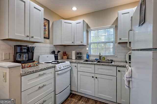 kitchen featuring dark hardwood / wood-style flooring, sink, white cabinets, and white appliances