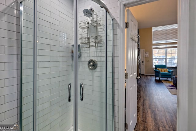 bathroom featuring wood-type flooring and walk in shower