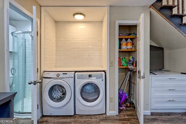 laundry room featuring dark hardwood / wood-style flooring and washing machine and dryer