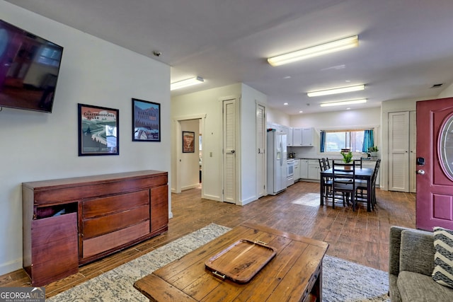 living room featuring dark wood-type flooring