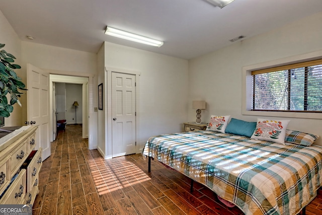 bedroom featuring dark hardwood / wood-style flooring