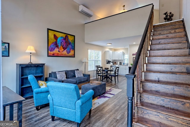 living room featuring a wall mounted air conditioner and wood-type flooring