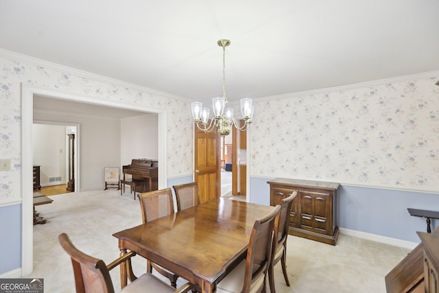 carpeted dining room with an inviting chandelier and ornamental molding