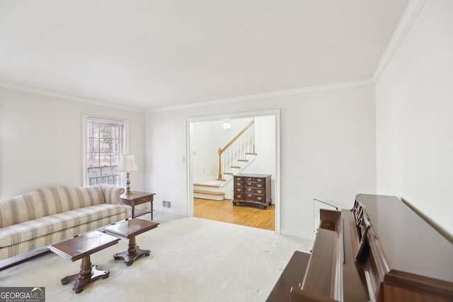 living room with ornamental molding and light carpet