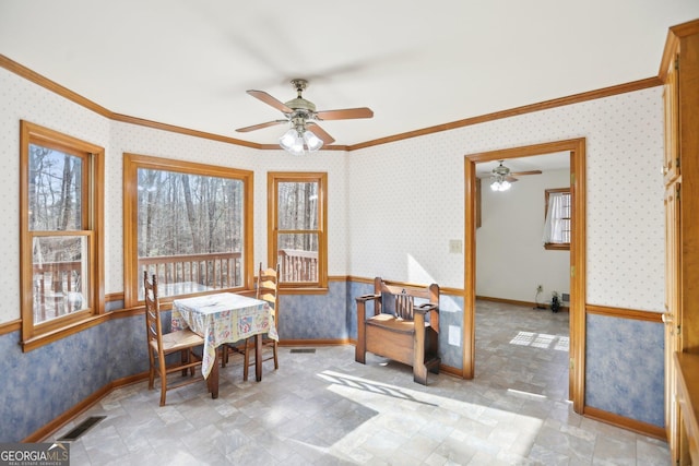 sunroom featuring ceiling fan