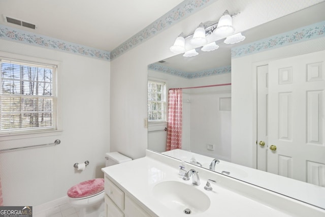 bathroom with vanity, toilet, and curtained shower