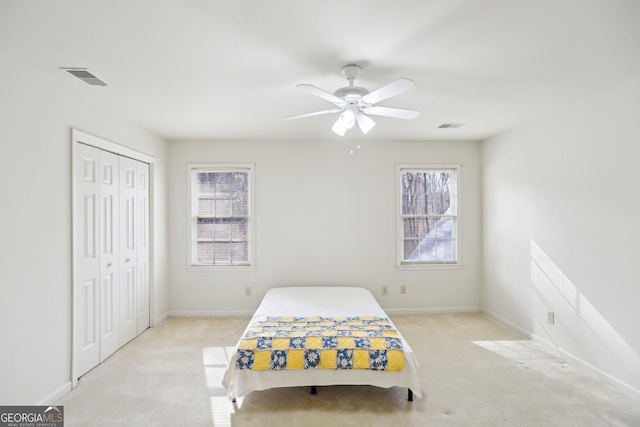 carpeted bedroom with a closet and ceiling fan