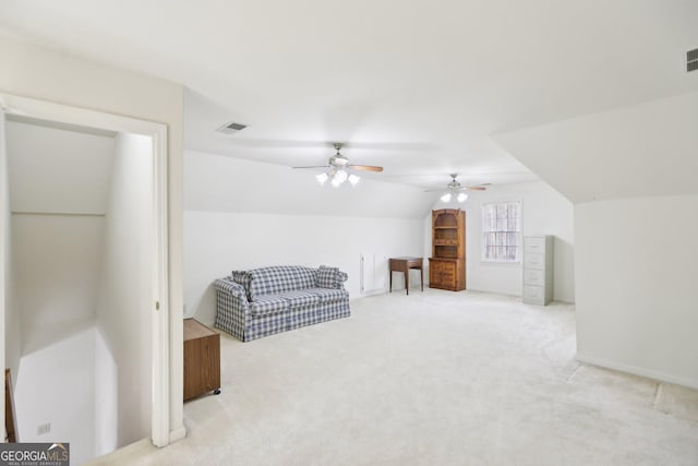 living area featuring lofted ceiling and light colored carpet