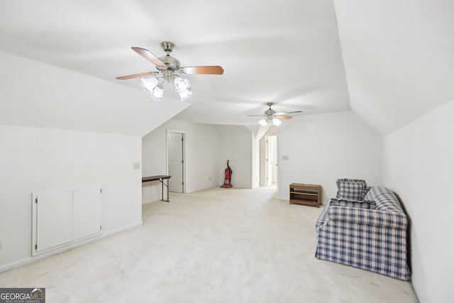 additional living space with ceiling fan, vaulted ceiling, and light carpet