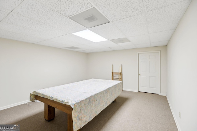 bedroom with carpet and a paneled ceiling