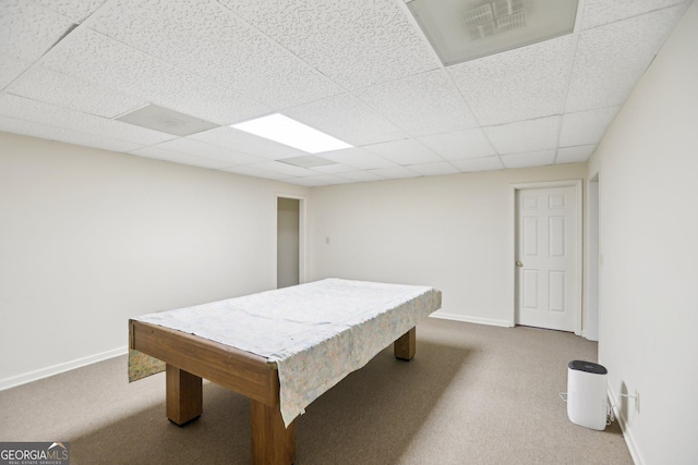 rec room with a drop ceiling and light colored carpet