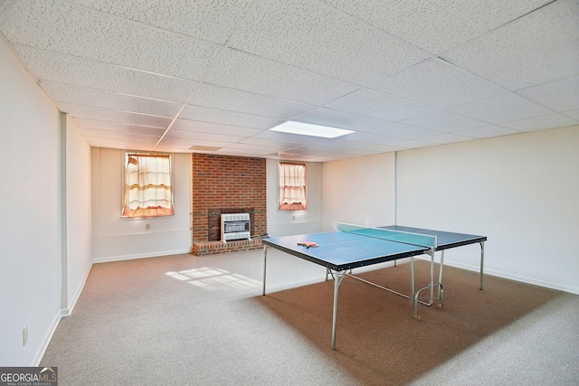 game room with a healthy amount of sunlight, heating unit, a fireplace, and carpet flooring