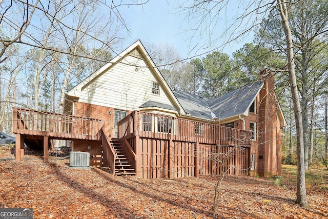 back of house with cooling unit and a deck