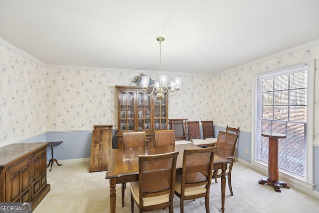 carpeted dining room featuring an inviting chandelier and crown molding