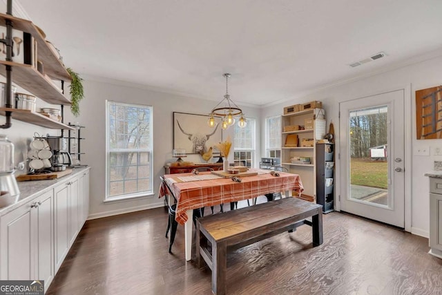 dining room with ornamental molding and dark wood-type flooring