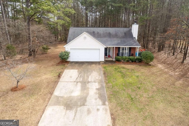 view of front of house with a garage and a front lawn