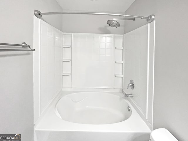 bathroom with shower / bathing tub combination and toilet