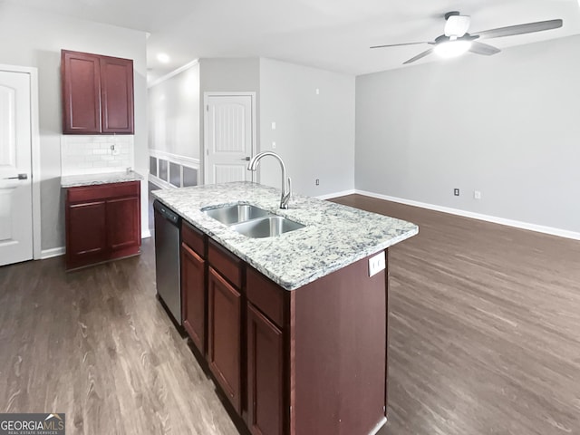 kitchen with an island with sink, sink, backsplash, stainless steel dishwasher, and dark wood-type flooring