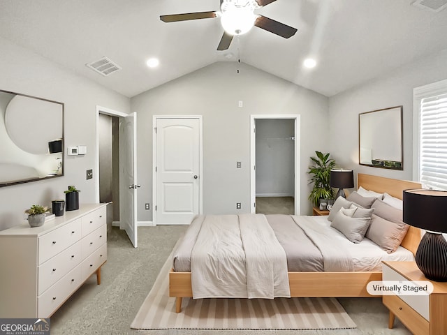 bedroom featuring vaulted ceiling, light carpet, and ceiling fan