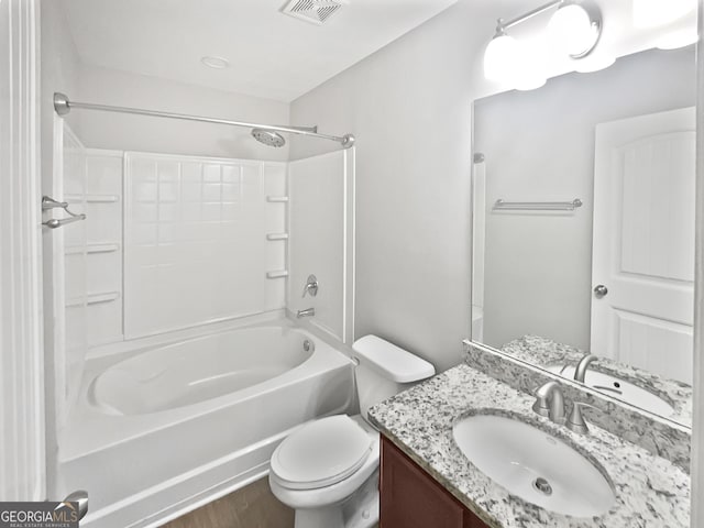 full bathroom featuring vanity, hardwood / wood-style floors, shower / tub combination, and toilet