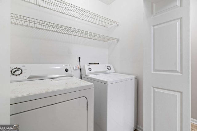 laundry area with separate washer and dryer