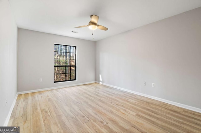 spare room with ceiling fan and light wood-type flooring