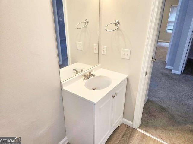 bathroom with vanity and wood-type flooring