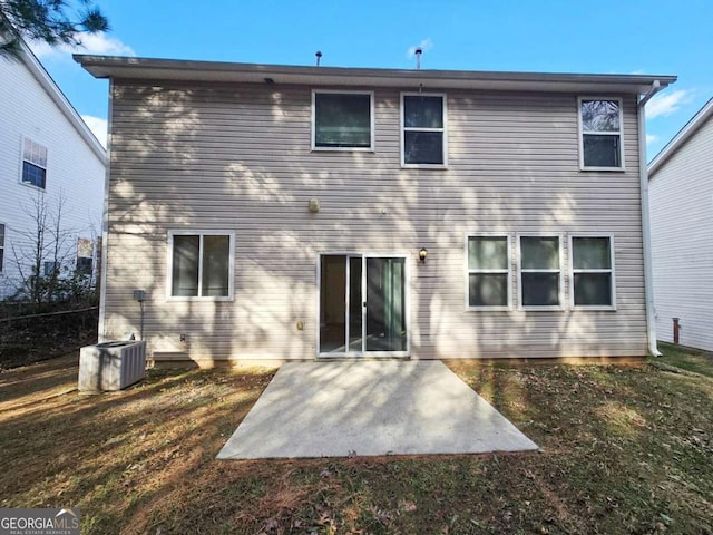 back of property with a yard, central AC, and a patio