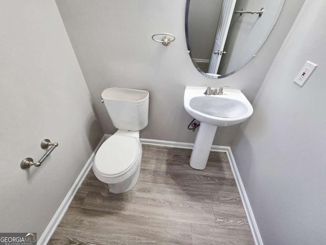 bathroom featuring toilet and hardwood / wood-style floors