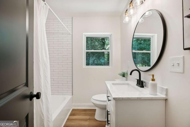 full bathroom with shower / tub combo with curtain, vanity, toilet, and hardwood / wood-style floors