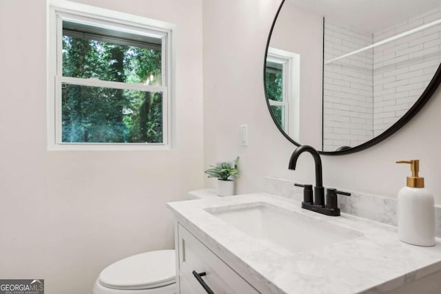 bathroom featuring vanity and toilet